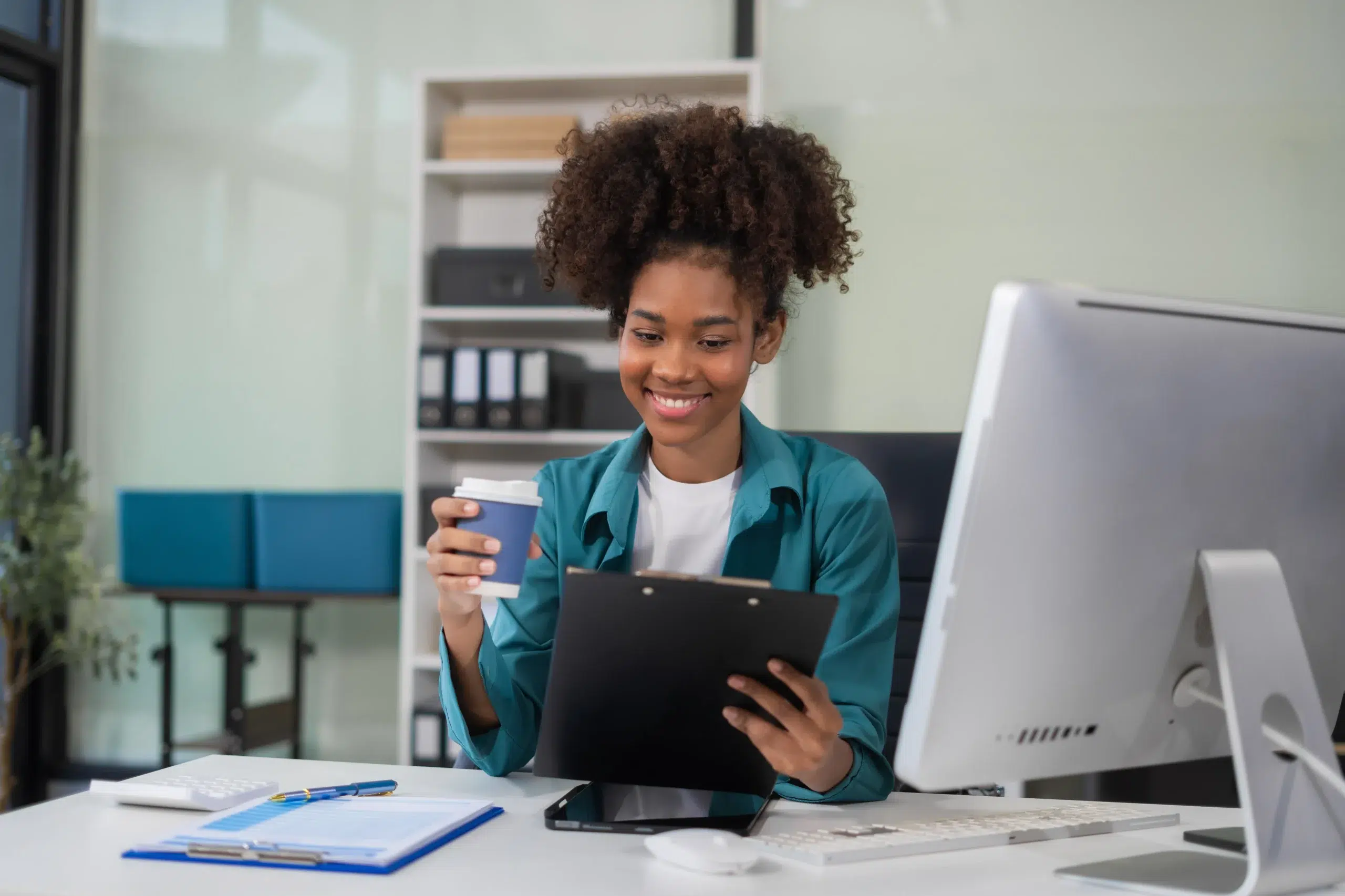 Healthcare billing manager smiling while auditing a claim report focused on optimizing pos 11 in medical billing reimbursements.