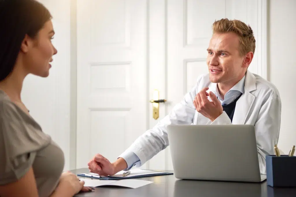 Doctor consulting with patient about medical billing for mental health.