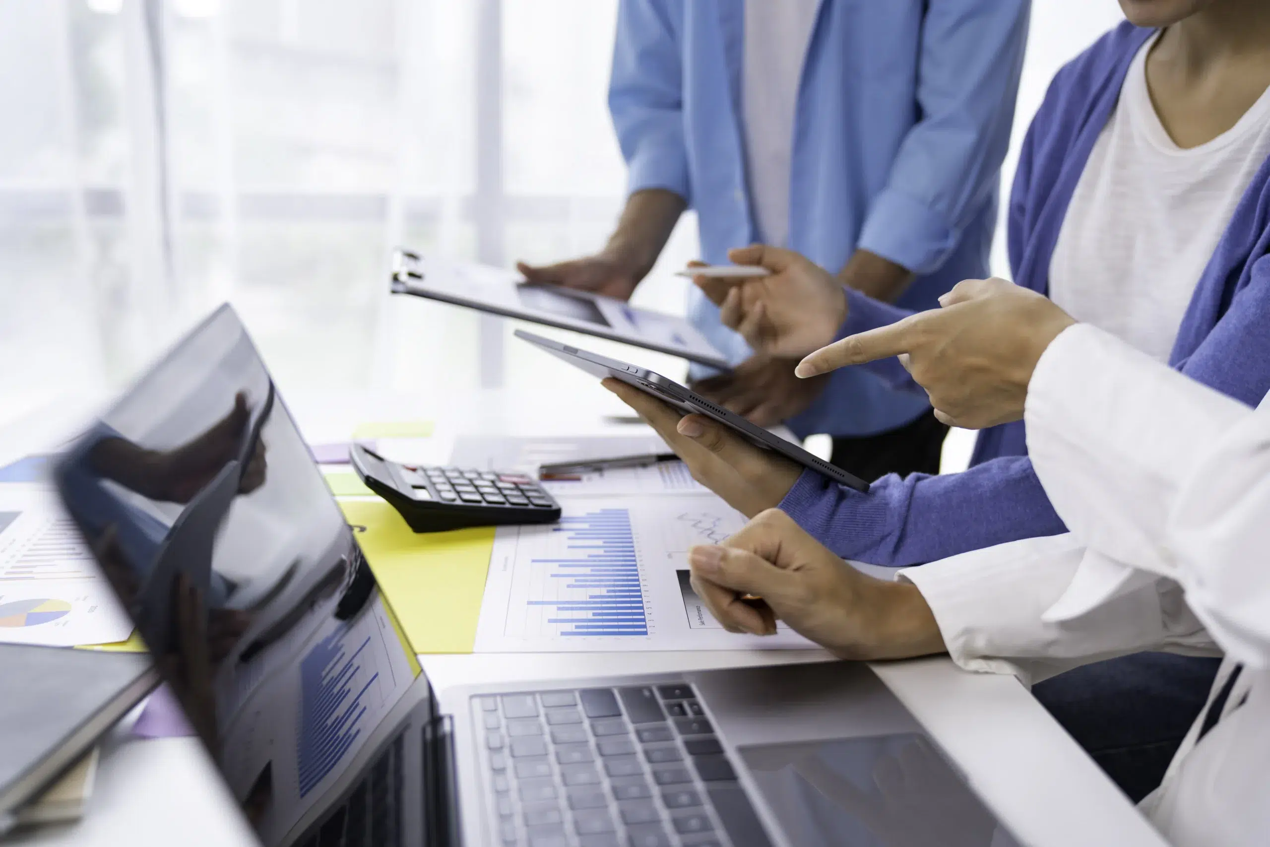 Business professionals comparing healthcare RCM companies using revenue cycle data and performance benchmarks